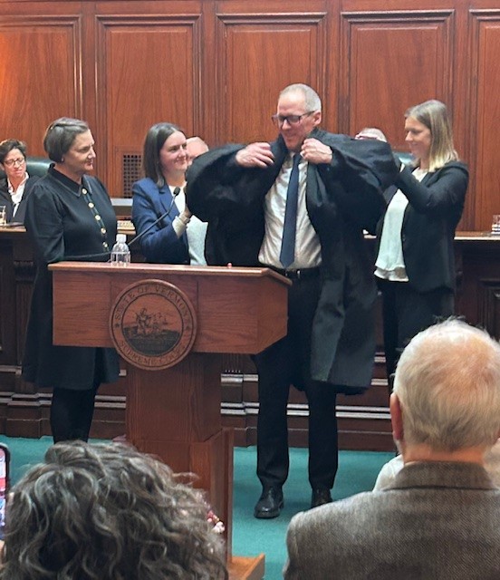 Justice Drescher’s family assists with the robing ceremony
